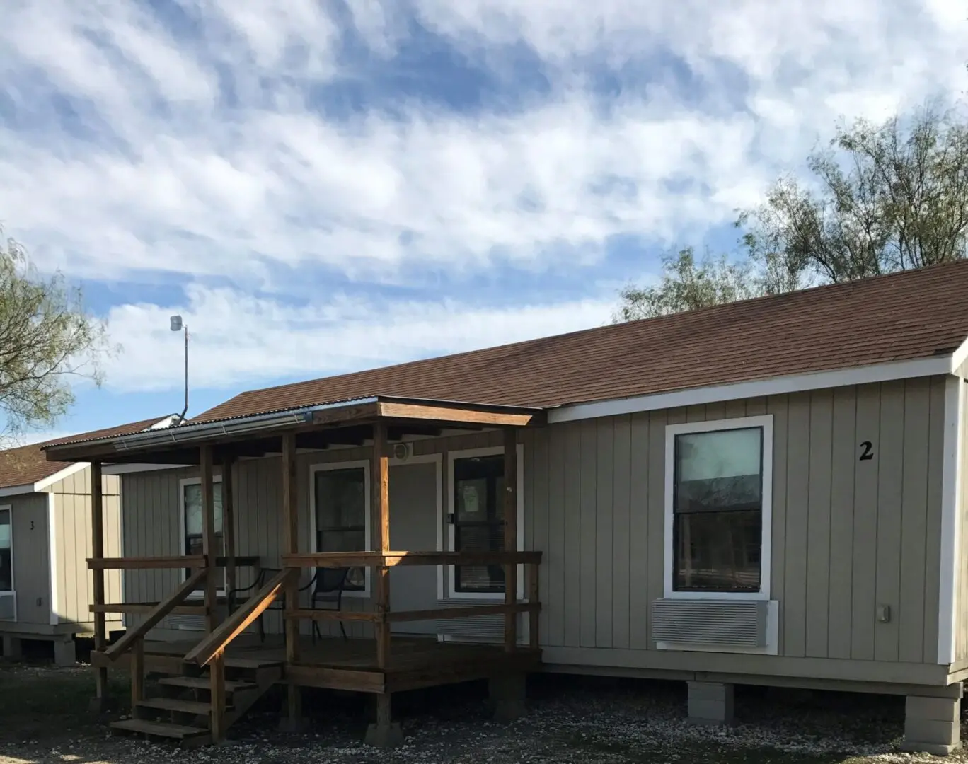 A house with a porch and a deck on the front.